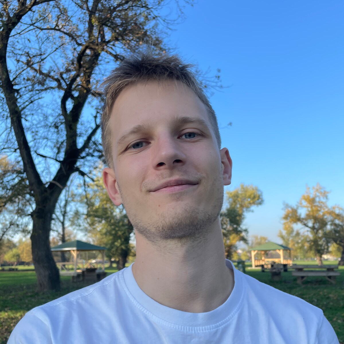 Portrait of Nino Nađ outdoors in a park.